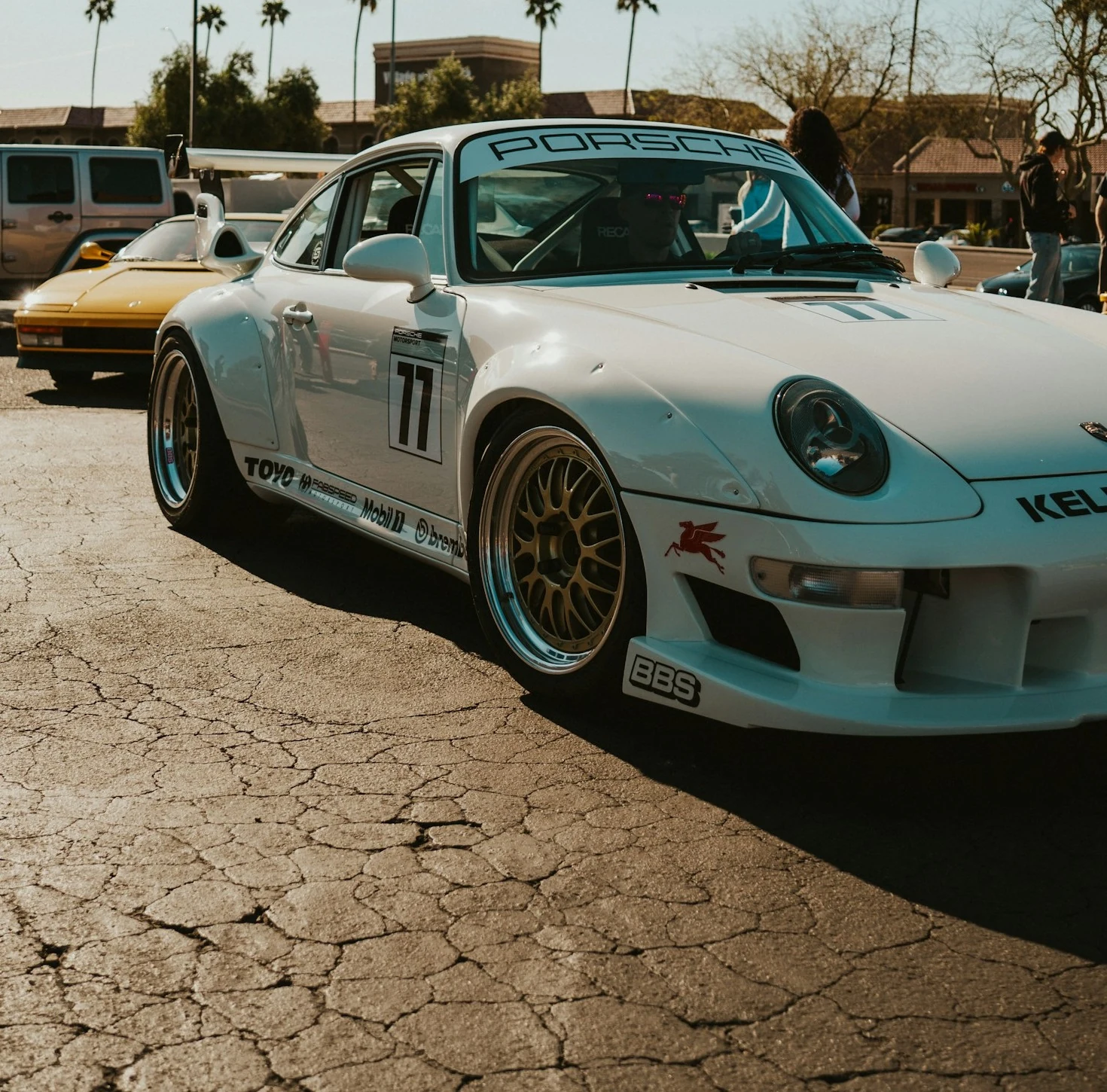 A tighter crop of the same vehicle photo, retaining the sports car and some surrounding parking lot